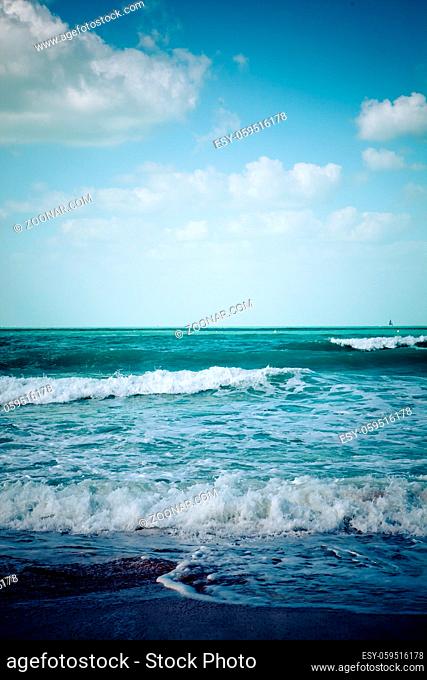 empty turquoise sea beach and white waves