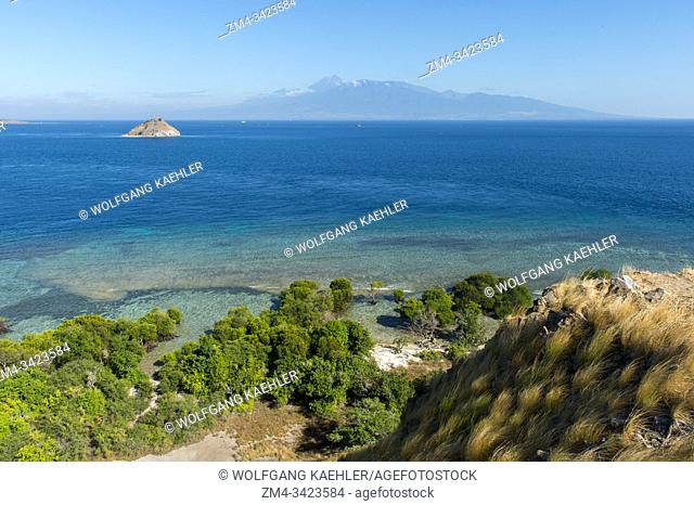 View from the hill on Gili Kenawa, a small island of the coast of Sumbawa, Indonesia, Lombok Island with the active volcano Mount Rinjani or Gunung Rinjani in...