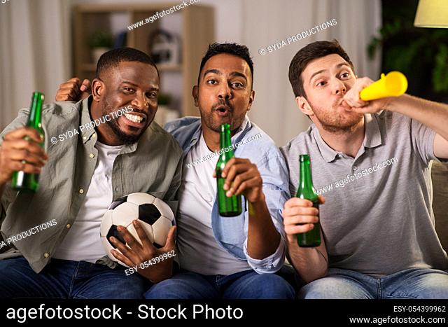 friends or soccer fans with ball and beer at home