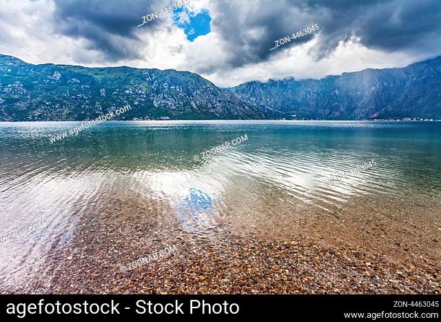 Early misty morning on the beach with sea and mountain views. Kotor bay. Montenegro