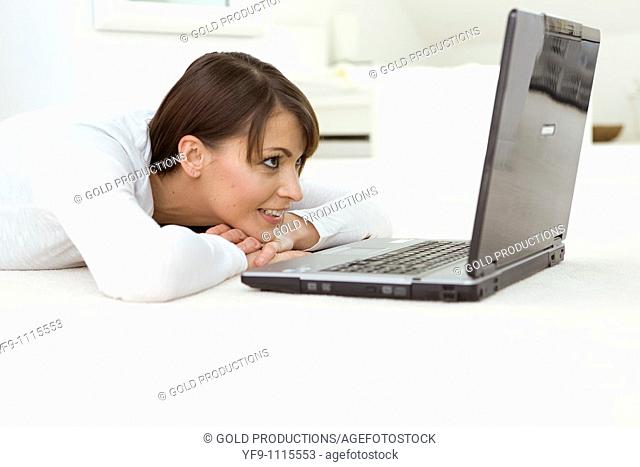 Woman in bed with computer