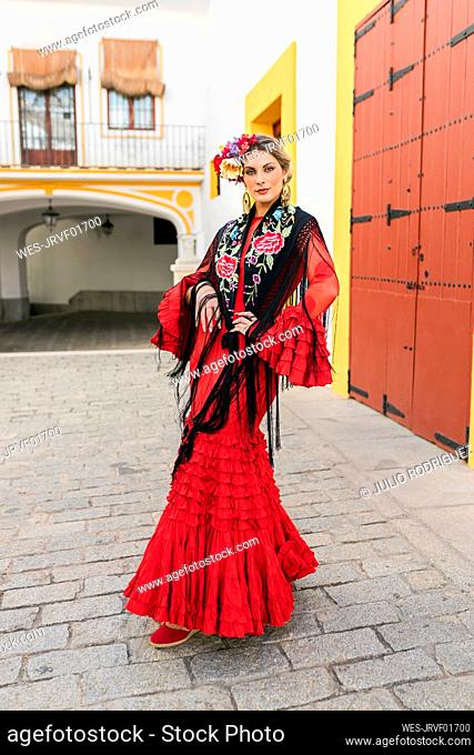 Female flamenco artist standing at Plaza de toros de la Real Maestranza de Caballeria de Sevilla, Spain