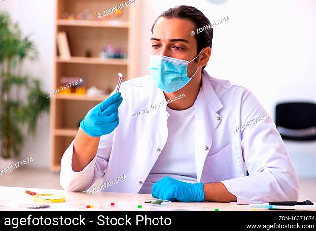 Young chemist working in the lab during pandemic