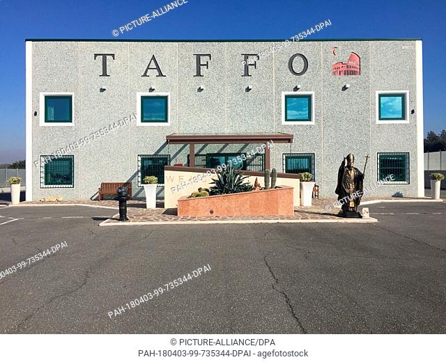 30 January 2018, Italy, Rome: The offices of the ""Taffo"" undertaker's, with a life-sized statue of Pope John Paul II standing before it