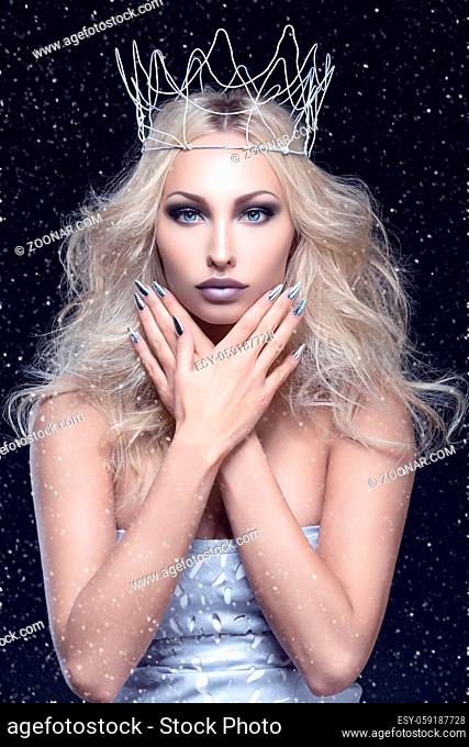 Beautiful young woman with crown. Cold tones. Copy space
