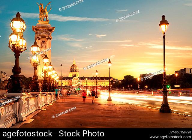 View on Les Invalides from bridge Alexandre III in Paris at sunset, France