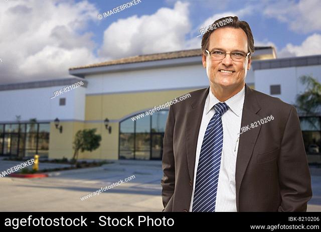 Handsome bussinesman in front of vacant office building