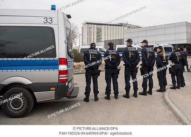 26 March 2018, Germany, Stuttgart: Police officers standing at the entrance to the court before the start of the trial against alleged leader of the Turkish...