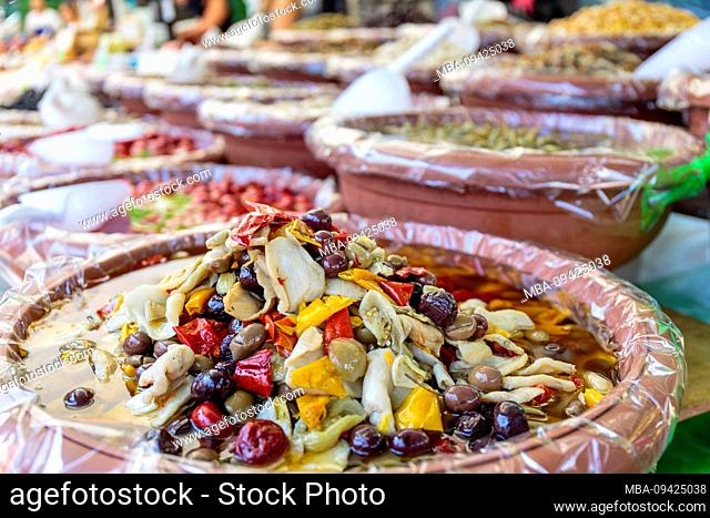 Europe, Italy, Piedmont, Cannobio. Jugs with antipasti at the stall of a trader at the weekly market
