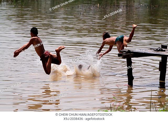 Young Intha boys swimming on the River, Inle lake, Shan state, Myanmar, Burma