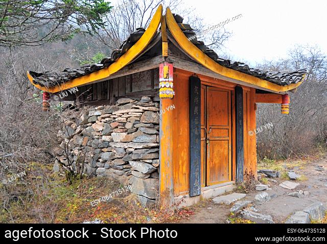 Photo of a Chinese Tibetan style house in the woods