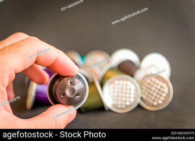 Colorful espresso coffee capsules used on black background, recycling, environment