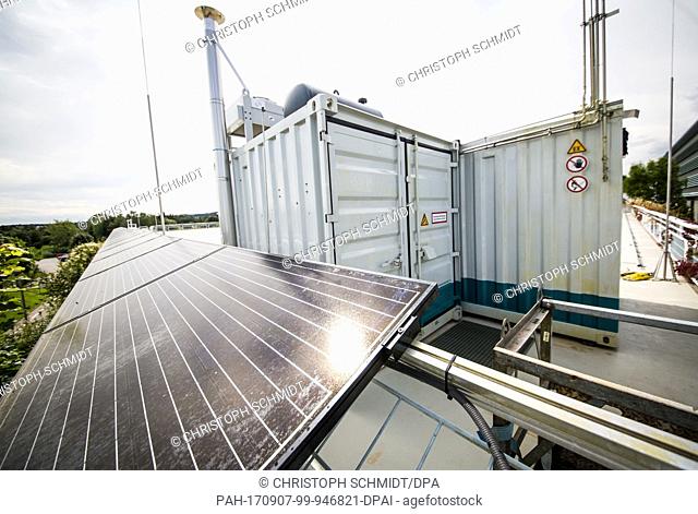 The sun shines on a photovoltaic installation on the roof of the Fraunhofer Institute for Industrial Engineering (IAO) in Stuttgart, Germany, 4 September 2017