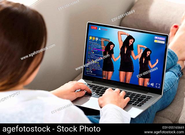 Woman Sitting On Couch Doing Online Shopping On Laptop