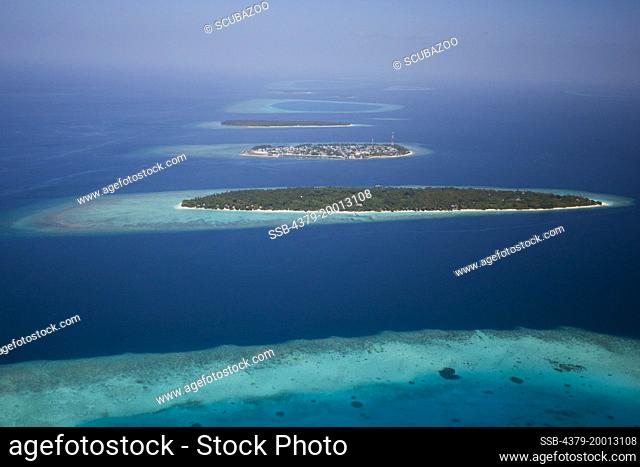 Aerial view of Soneva Fushi Island Resort, with Eydhafushi local island behind, Baa Atoll, Maldives