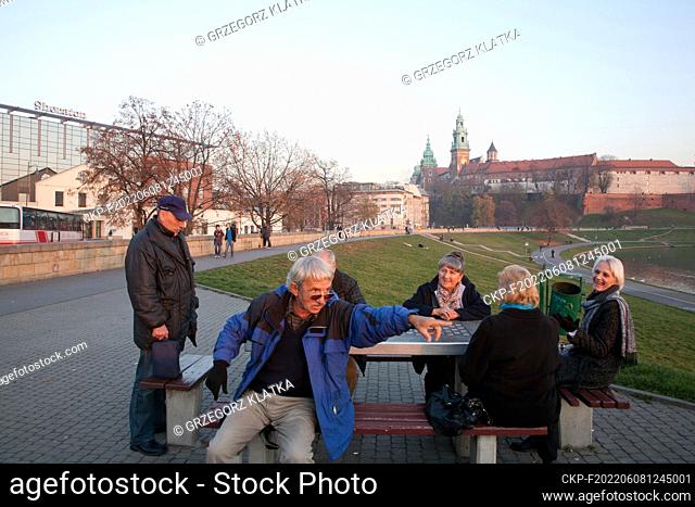 Nov 9, 2011. People playing outdoor chess on the Vistula boulevard. Royal Castle on the Wawel hill (right) and Sheraton hotel (left) are visible at the...