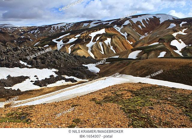 Cooled lava field with snow fields in a volcanic landscape, Landmannalaugar, Iceland, Europe