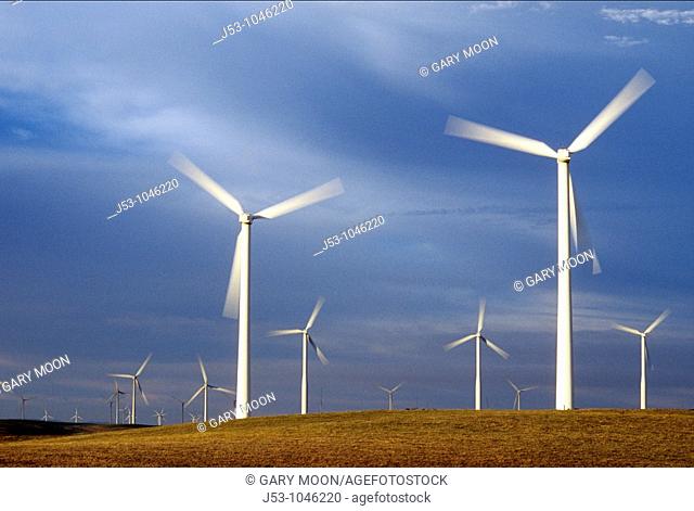 Spinning wind turbines at dusk, Rio Vista, California USA