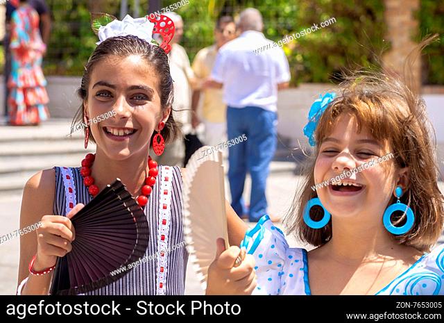 MALAGA, SPAIN - AUGUST, 14: Little girls in flamenco style dress at the Malaga August Fair on August, 14, 2009 in Malaga, Spain