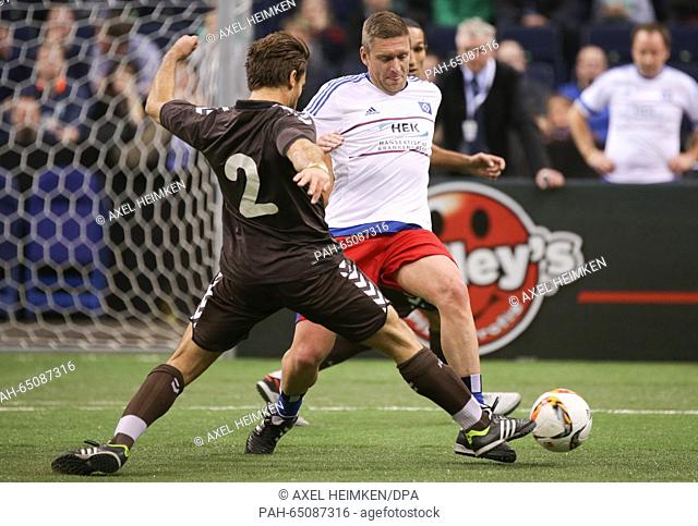 St. Pauli's Florian Lechner (L) and Hamburg's Christian Rahn vie for the ball at the 'Hero Cup' indoor tournament with all-stars from Hamburger SV, FC St