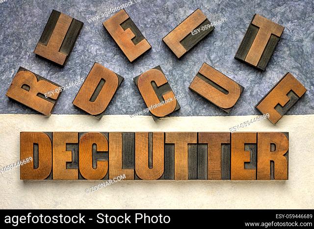 declutter word in vintage letterpress wood type against handmade textured amate paper, inspiration, motivation, simplicity, minimalism and lifestyle concept