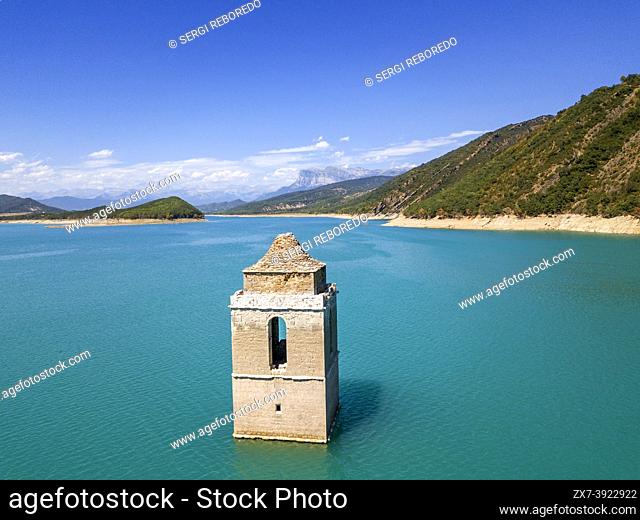 Mediano swamp and tower church submerged under water. View of Sobrarbe Aragon region and Peña Montañesa and the Monte Perdido massif from the Mediano reservoir...