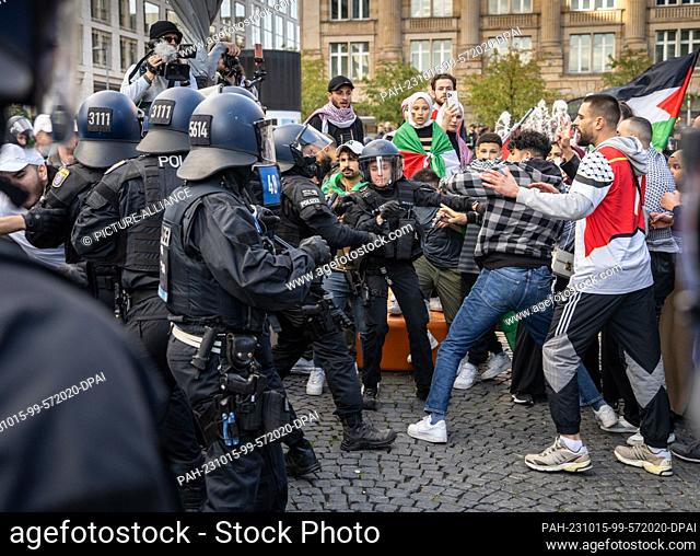 14 October 2023, Hesse, Frankfurt/Main: Police officers try to take away participants of an unauthorized pro-Palestine demonstration in order to establish their...