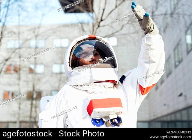 Female astronaut shielding eyes during sunny day