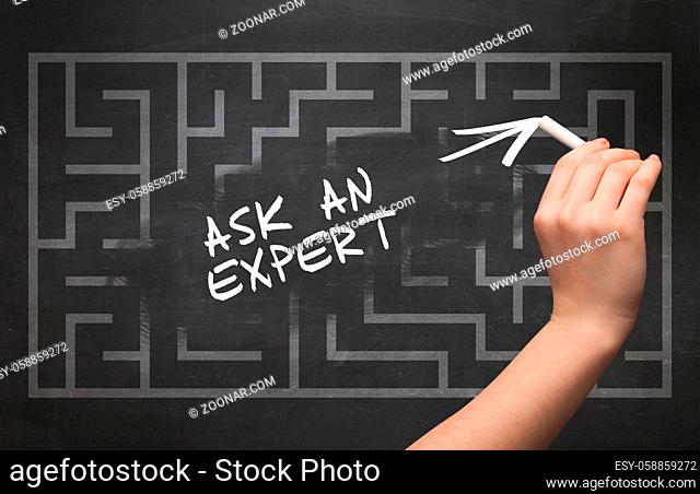 Hand drawing ASK AN EXPERT inscription with white chalk on blackboard, new business concept