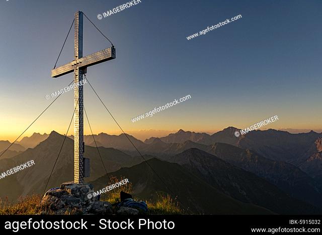 Summit cross of Kreuzspitze, in the background the Lechtal Alps at sunrise, Elmen, Lechtal Alps, Außerfern, Tyrol, Austria, Europe