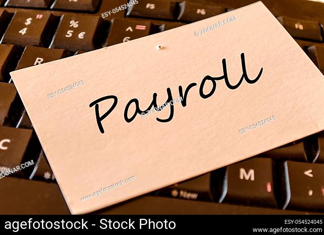 Payroll - note on keyboard in the office