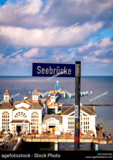 Sellin, Mecklenburg-Western Pomerania, Germany - September 30, 2020: Street sign Seebrucke (German for: Sea-Bridge) with a part of the Sellin Pier in the...