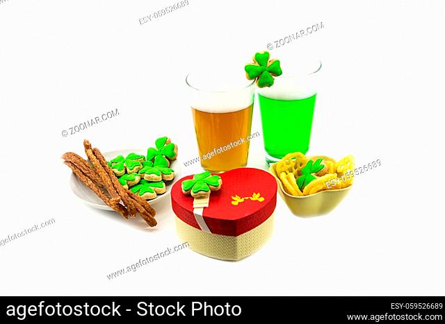 Two glasses of beer with high foam green lager with snacks meat sticks gift box. St.Patrick 's Day