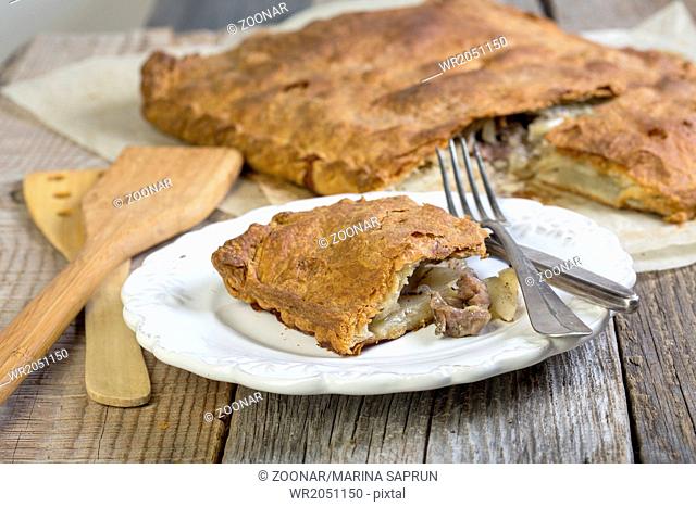 Pie with meat and potatoes on the plate