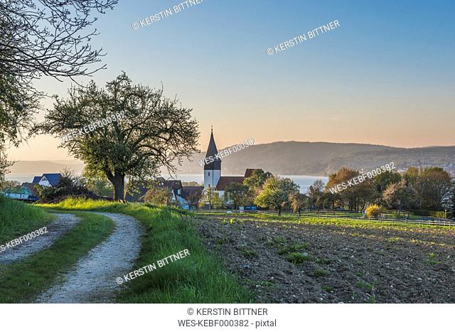 Germany, Dingelsdorf, View to St. Nicholas' Church in the evening
