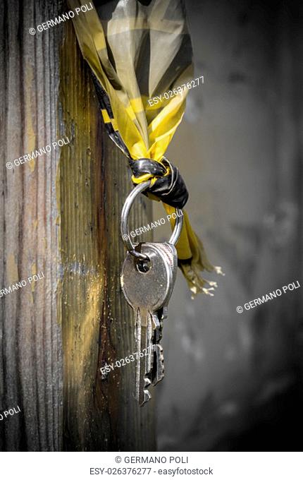 Metal keys hanging from a wooden pole
