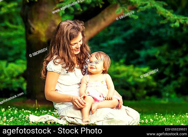 Mother and little daughter playing in the park
