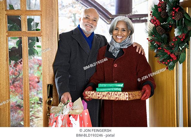 African American couple arriving with Christmas gifts