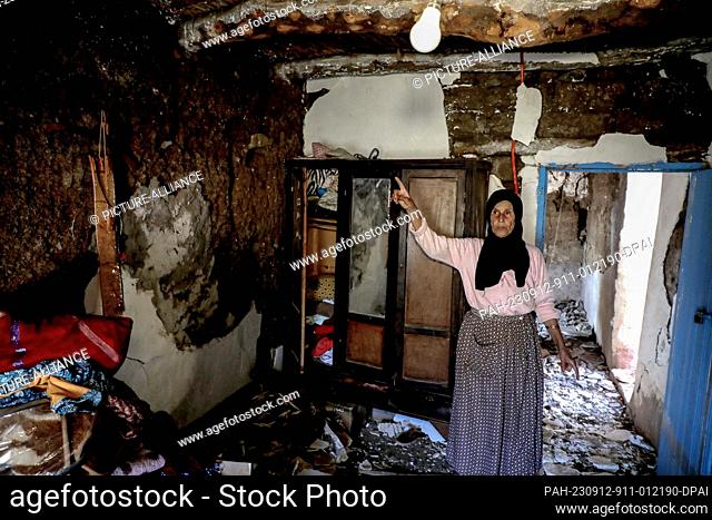 12 September 2023, Morocco, Al Haouz: Zahra, 60 years old, stands inside her damaged house in Asni Town following the powerful earthquake that hit Morocco late...