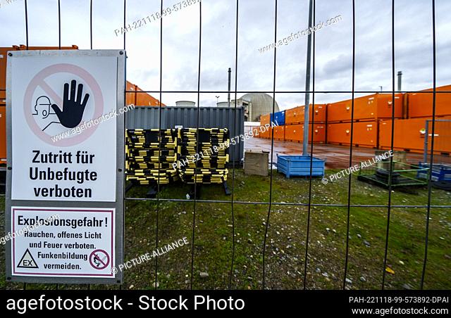 18 November 2022, Hessen, Biblis: Containers with contaminated material stand behind a construction fence in front of a power plant unit at the Biblis site