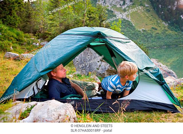 Father and son relaxing in tent