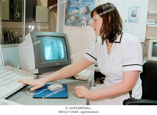 Superintendent Radiographer in Intervention room looking at digital image of a chest from an xray camera