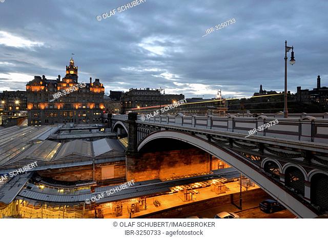 Views of the old town illuminated in the evening with the tower of the Balmoral Hotel, Waverley Station, Calton Hill, North Bridge, Edinburgh, Scotland