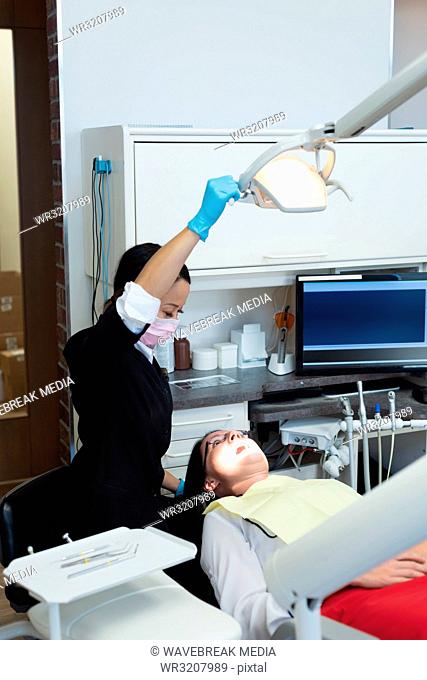 Female dentist examining a patient