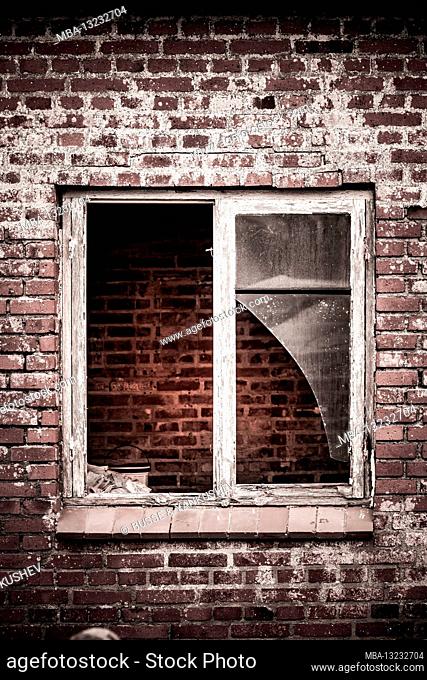 Old broken window in a brick building