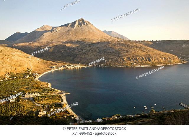Looking down on Itylo bay and the village of Neo Itylo at sunset, with the Taygetos mountains in the background, the Mani, Southern Peloponnese, Greece