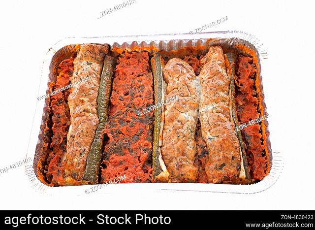 stuffed zucchini in front of white background