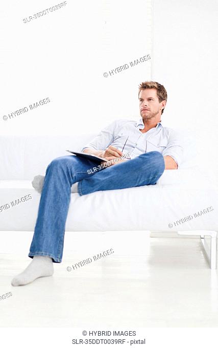 Man watching television on couch