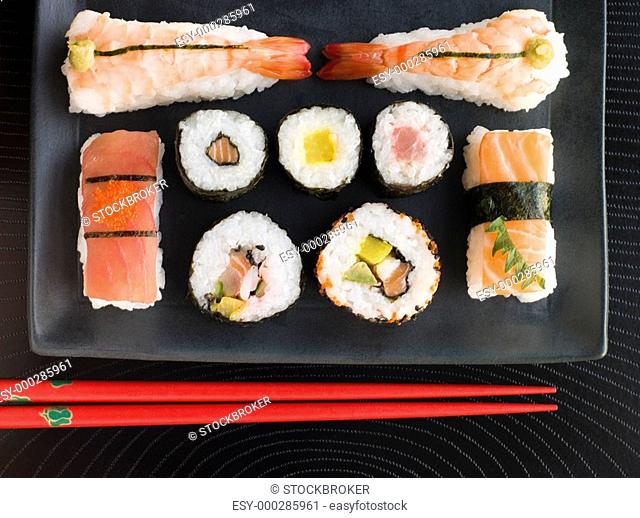 Selection of Seafood And Vegetable Sushi With Chopsticks Overhead
