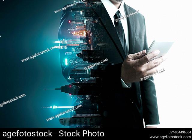 Abstract double exposure image of businessman man using mobile smart phone mix with flip night creative city background